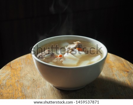 Bowl of clear white radish soup with pork bone and goji berry Stock photo © 