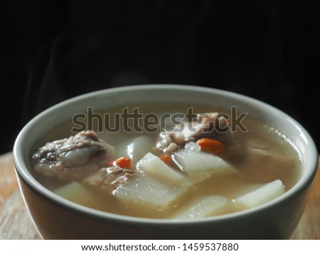 Bowl of clear white radish soup with pork bone and goji berry Stock photo © 
