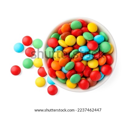 Bowl with colorful candies on white background, top view