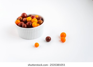 Bowl of colorful cherry tomatoes on a white background,fresh produce. - Powered by Shutterstock