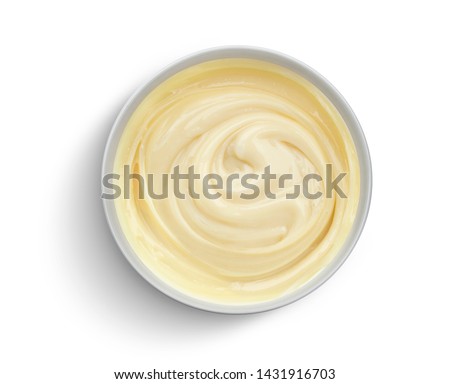 Bowl of condensed milk cream isolated on white background with clipping path, top view