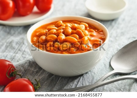 Bowl of cooked beans in tomato sauce
