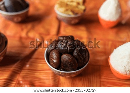 A bowl of cooked mushroom on the table. Ritual offerings to deity on a temple altar. Chinese sacrificial ceremonies for traditional festivals.