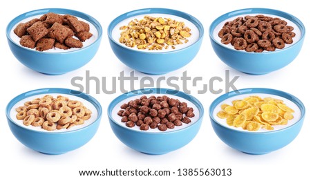 Bowl with corn pads, rings, balls, oat granola, cornflakes and yogurt isolated on white background. Cereals breakfast collection with clipping path.