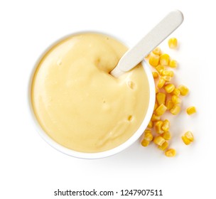 Bowl of corn porridge for babies isolated on white background, top view - Powered by Shutterstock