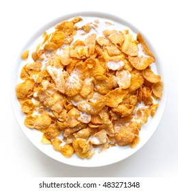 Bowl of cornflakes in milk isolated on white from above.