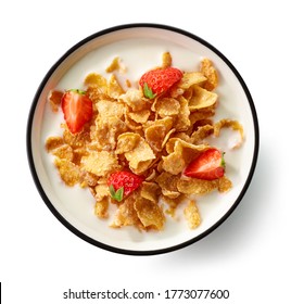 bowl of cornflakes with milk and strawberry pieces isolated on white background, top view