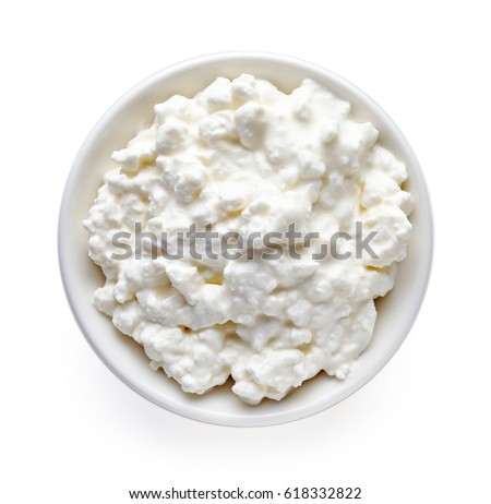 Bowl of cottage cheese isolated on white background, top view