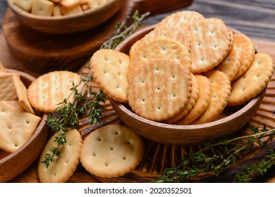 Bowl with crackers on wooden background
