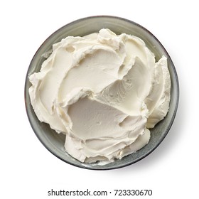 Bowl of cream cheese isolated on white background, top view