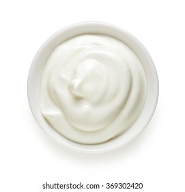 Bowl of cream on white background, top view