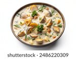 A bowl of creamy clam chowder with chunks of potatoes and herbs, top view, on a white background