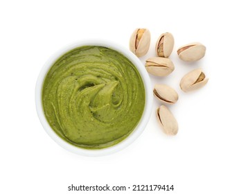 Bowl of creamy pistachio butter and nuts on white background, top view