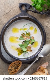 A Bowl Of Creamy Porcini Mushroom Soup On A Light Table