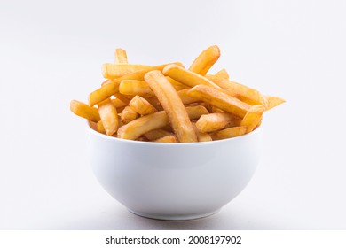 A bowl of crispy french fries isolated on white background.
