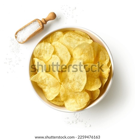 Bowl of crispy potato chips or crisps with salt isolated on white background, top view