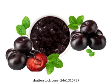 a bowl of dark cherry jam surrounded by whole cherries and mint leaves, the image is rich with deep reds and vibrant green, highlighting the lushness of the fruit. Stock Photo