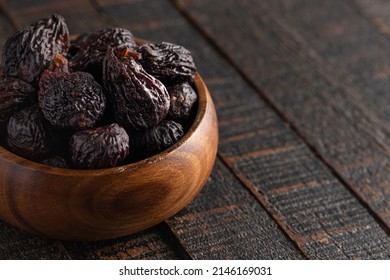 Bowl of Dark Dried Mission Figs on a Dark Wood Table - Powered by Shutterstock