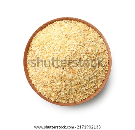 Bowl of dehydrated garlic granules isolated on white, top view