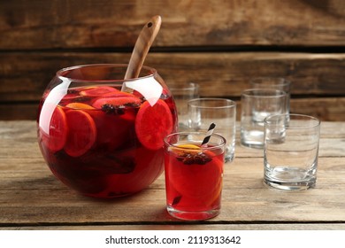 Bowl Of Delicious Aromatic Punch Drink And Glasses On Wooden Table