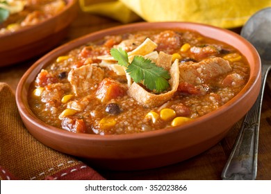 A Bowl Of Delicious Home Made Chicken Tortilla Soup With Chicken, Corn, Black Bean, Tomato, Homini, And Tortilla.