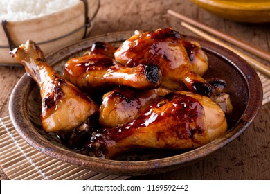 A bowl of delicious honey garlic chicken drumsticks with rice. - Powered by Shutterstock