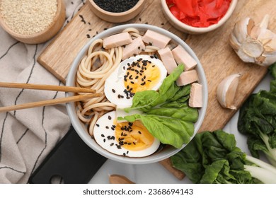 Bowl of delicious ramen with meat, egg and ingredients on table, flat lay. Noodle soup - Shutterstock ID 2368694143