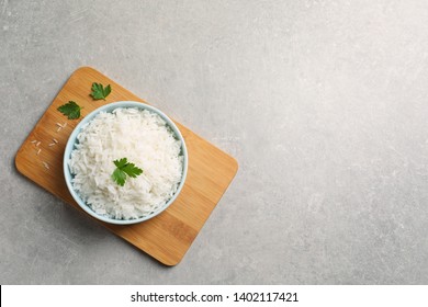 Bowl Of Delicious Rice On Table, Top View With Space For Text