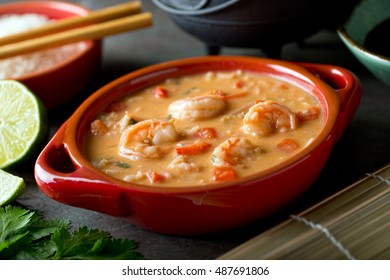 A Bowl Of Delicious Thai Red Curry Coconut Shrimp Soup With Rice.