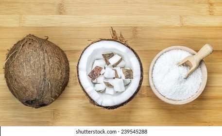 Bowl Of Desiccated Coconut Whole And Chunks On Wooden Table Background