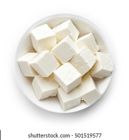 Bowl of diced soft cheese isolated on white background, top view