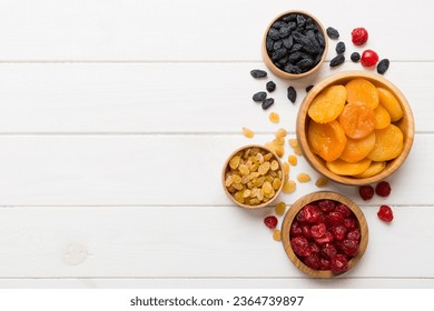 Bowl with different dried fruits on table background, top view. Healthy lifestyle with copy space. - Shutterstock ID 2364739897