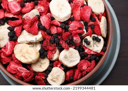 Bowl of different freeze dried fruits on table, closeup