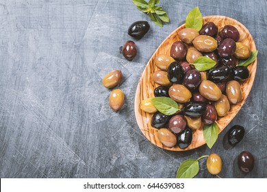 Bowl With Different Kind Of Pickled Olives Green, Black, Kalamata Olives Over Chalk Board Background, Top View