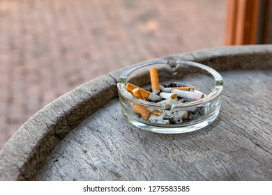 Bowl For Disposable Cigarettes;The Glass Ashtray Is Filled With Cigarette Smoke;Smoking Point;Smoking Cigarettes.