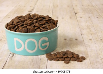 Bowl With Dog Food On A Hardwood Floor.