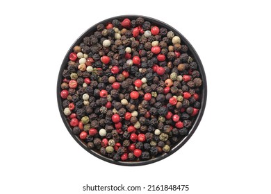 Bowl of dried aromatic peppercorns, isolated on white. Colourful pepper mix - black, red, green and white peppercorns. Top view.
