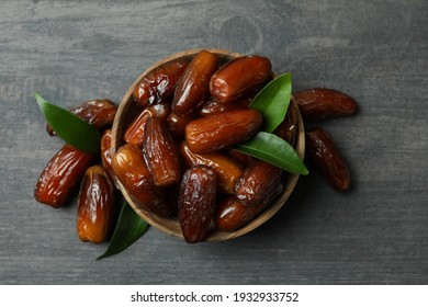 Bowl of dried dates on gray textured background