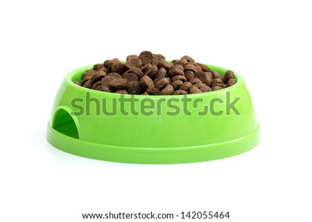 bowl with dry food for dog or cat isolated on white background