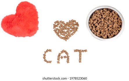 Bowl With Dry Pet Food And A Red Heart Toy On A White Background. With Love For The Concept Of Animals And Valentine's Day. View From Above. Copy Space.