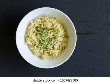 Bowl Of Egg Noodles Isolated On Rustic Black Table - Top View Photo