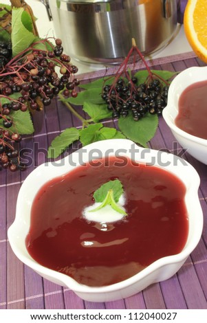 a bowl with Elderberry soup of fresh elderberries Stock photo © 
