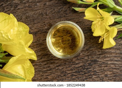 A Bowl Of Evening Primrose Oil With Fresh Flowers, Top View