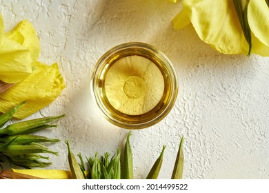 A Bowl Of Evening Primrose Oil With Fresh Blooming Plant , Top View