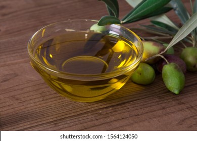 bowl of extra virgin olive oil with olives