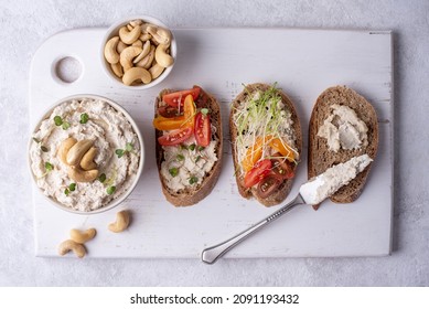 Bowl With Fermented Vegan Nut Cheese On A White Background, Sandwiches With Cashew Cream Cheese On A Cutting Board, Healthy Food Concept.