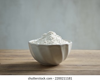 Bowl Of Flour On Wooden Kitchen Table