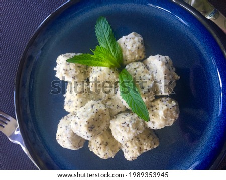 A bowl of food on a blue plate. High quality photo