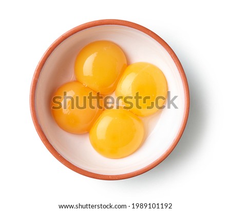 bowl of four egg yolks isolated on white background, top view