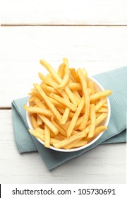 Bowl Of French Fries On A Turquoise Napkin, Top View